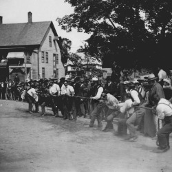 Tug-of-war in front of the store circa 1900